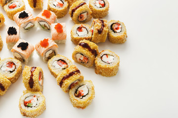 Top view on sushi rolls on white background
