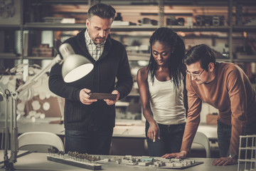 Multiracial team working in design and engineering architecture office.
