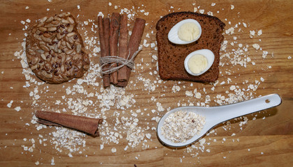 quail eggs on a black bread and oat chips and cookie and a cinnamon stick