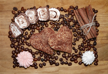 cookies and meringue and cinnamon stick and coffee beans and turkish delight on a broun wooden table