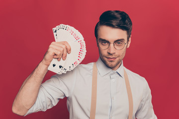 Professional, cunning magician, illusionist, gambler in casual outfit, glasses, holding, showing...