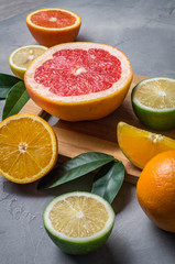 Fototapeta na wymiar raw food: slicing citrus fruits. Orange, tangerine, lemon lime grapefruit
