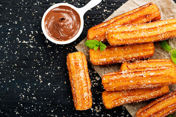 Churros with sugar and chocolate sauce . top view 