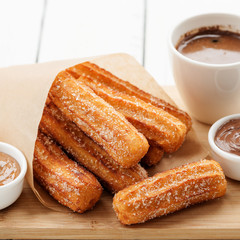 Churros with sugar and chocolate sauce . top view 