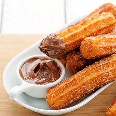 Churros with sugar and chocolate sauce . top view 
