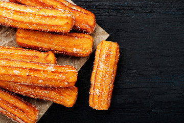 Churros with sugar and chocolate sauce . top view 