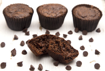 Whole Wheat Double Chocolate Chip Muffins on a Rustic White Wood Table