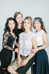 Young beautiful women with a beautiful diadem in their hair poses on white background.