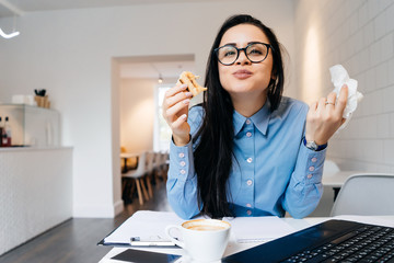hungry woman eats at the office at a sandwich table