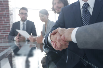 handshake of business partners in conference room