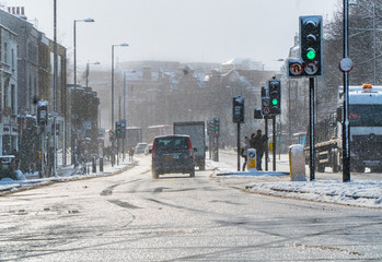 Black cab on Islington driveway daylight snow