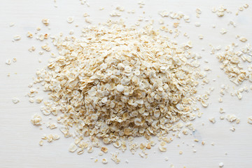 heap of rolled oats on a white background