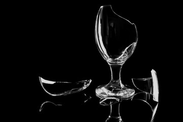 Glass shattered glass on a black background with reflection.