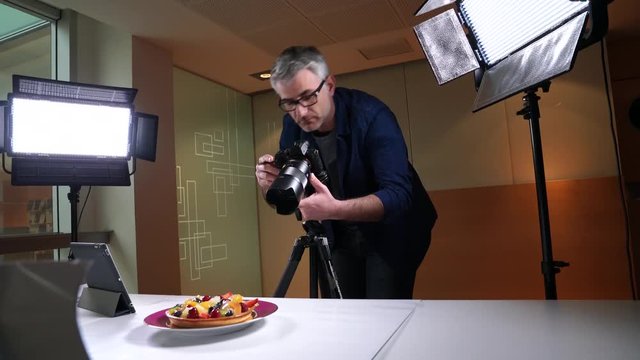 photographer in photo studio shooting culinary pictures