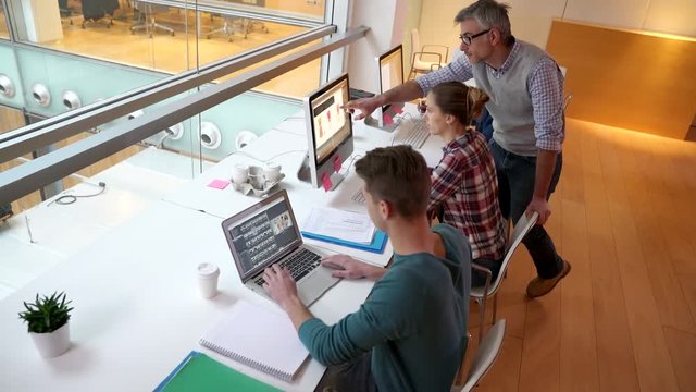Upper view of students in class working on computers
