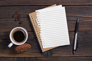 Coffee with cookie, notebook and pen