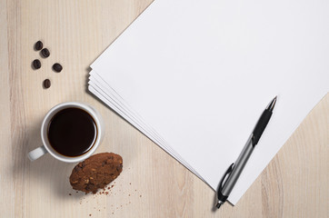 Sheets of paper and coffee with cookies