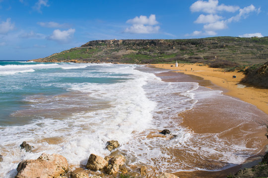 Waves wash over Ramla Beach on the island of Gozo, Malta