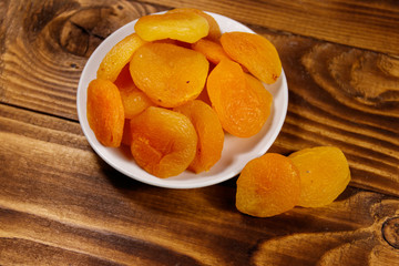 Dried apricots on wooden table