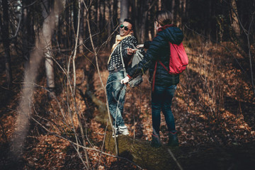 Father giving hand to a daughter in the forest