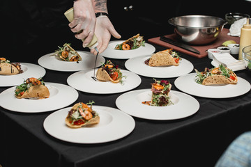 The chef at the restaurant making Spicy Shrimp Tacos with Coleslaw and Salsa