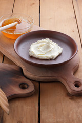 Sour cream, cream, fresh sour cream in pottery on a wooden background, dairy products and honey, wooden board, French breakfast, healthy food, sour cream and honey in a rustic style, minimalism, copy 