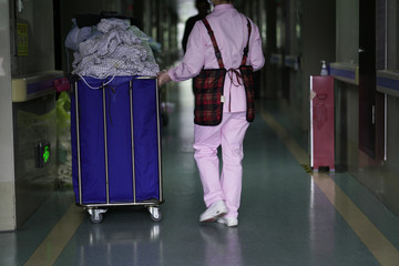 nurse carry clothes to laundry room in the hospital