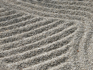 close-up of zen lines in gravel of a japanese garden