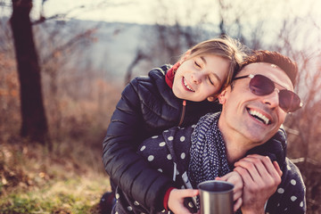 Daughter embracing her father