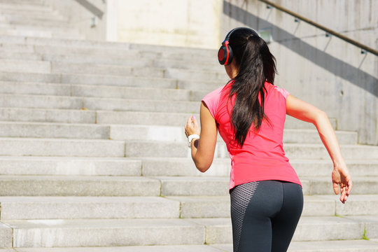 Young, fit and sporty woman running up the stairs. Fitness, sport, urban jogging and healthy lifestyle concept.