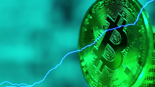 Blockchain technology, bitcoins mining concept in green light with lightnings, macro shot of bitcoins. Cryptocurrency Bitcoin, BTC, power consumption concept