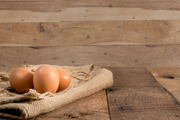 Freshly laid organic eggs on wooden bench