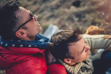 Gay male couple embracing outdoors