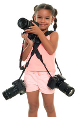 Small multiracial girl carrying three professional cameras