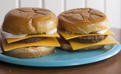 A pair of veggie cheeseburgers on sweet buns
