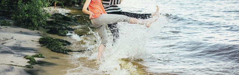 river splash legs two girls on the beach
