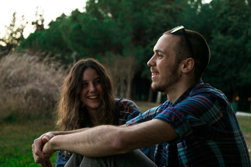 Fototapeta premium Two friends having fun in the middle of a park in a cloudy afternoon in Seville, Spain. At february of 2018