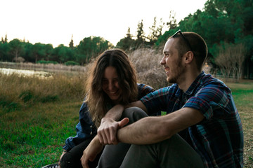 Two friends having fun in the middle of a park in a cloudy afternoon in Seville, Spain. At february of 2018