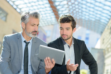Businessmen looking at tablet