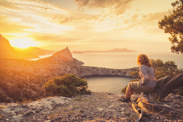 Girl tourist admiring the beautiful sunset