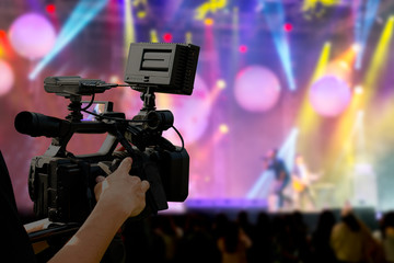 The filmmaker is recording and broadcasting live concerts on camcorders. Professional Video...