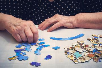 Old lady doing a puzzle