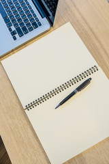 Laptop, Pencils, Notebook on wooden office table. Business concept.