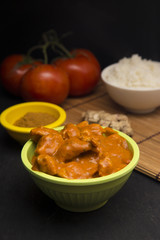 A Bowl of Chicken Tikka Masala on a Slate Chalkboard