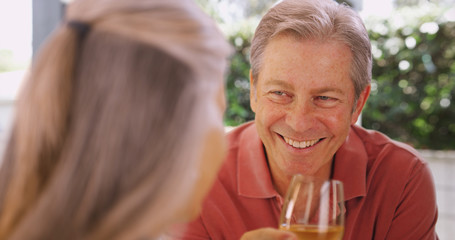 Couple of middle aged friends having daytime drink together
