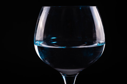 Red wine glass silhouette on black background