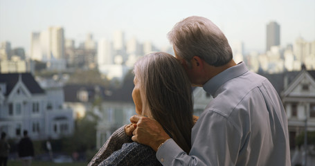 Rear view of mature couple looking at Golden Gate bridge San Francisco