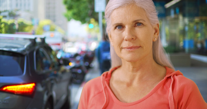 An Older Woman Stands On A San Francisco Street Corner. An Elderly Woman Poses For A Portrait On A San Francisco Plaza