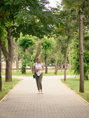 Woman in the Park. Business suit. Nature walk.