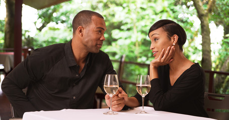 A black man proposes to his girlfriend. An African American couple get engaged